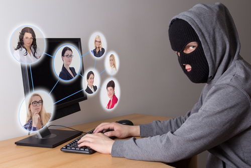 masked hacker stealing data from computers